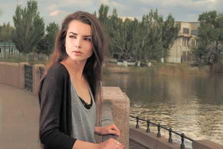 Pretty girl waiting for your. Wearing light gray shirt, black jacket, an young american woman...