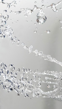 Splashed water drops. Fresh transparent water Natural background.の写真素材