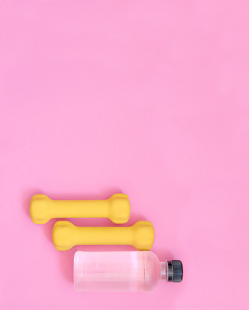 Sport, fitness, healthy lifestyle concept - dumbbells and water bottle set from above viewの写真素材