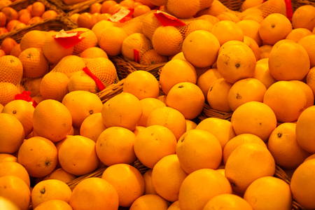 Bunch of fresh mandarin or oranges on market table. Many oranges stacked.の写真素材