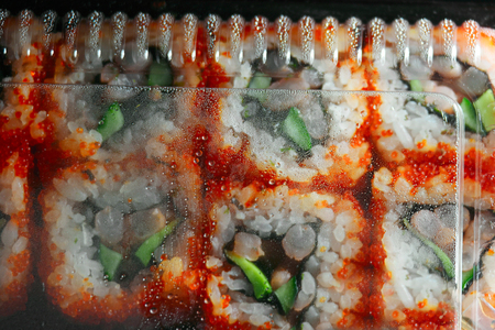 Japan sushi in packaging box top view, drops of water on inner side of plastic coverの写真素材