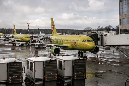 Moscow Russia 28 of Feb. 2016: Siberia Airlines S7 airlainers in bright green levree in Domodedovo airport after night snowfall under low cloudy skyのeditorial素材