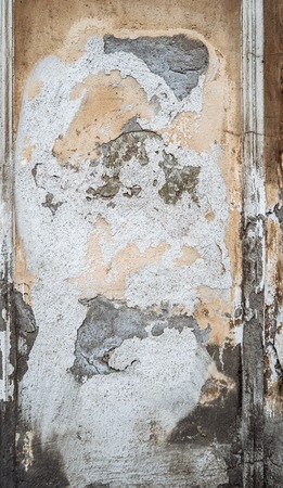 Grungy wall background. Abandoned plaster over old cement wall.