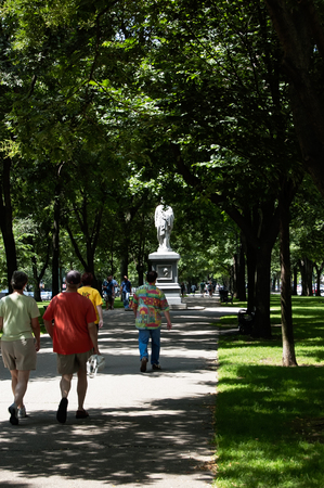 Boston,Massachusetts, US, 27 Jul. 2009: Pedestrian walking towards Hamilton statute on Commonwealth Avenue. The statue was funded by Thomas Lee and designed by Dr. William Rimmer.のeditorial素材