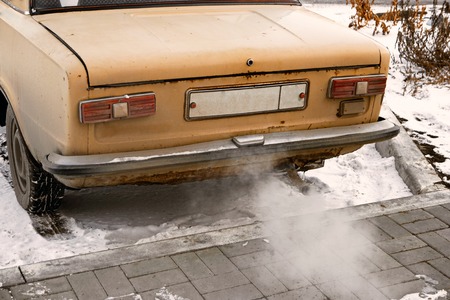 Old car smoking, environmentally dangerous vehicle vintage color-lookの写真素材