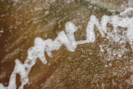 Long water splash of fountain frozen in an air.の写真素材