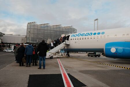Cologne, Germany, 16 of december 2017: Passengers getting on board of one of Pobeda-Airlines low coster company aircraft, the only lowcoster in Russiaのeditorial素材