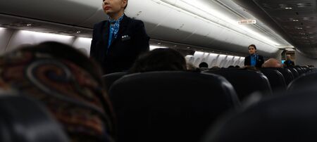 Cologne, Germany, 16 of december 2017: Flight attendant Show how to deal with safty equipment on board of one of Pobeda-airlines low coster company aircrafts.のeditorial素材