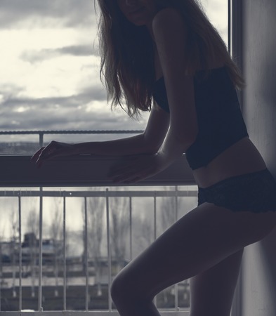 Sexy Girl In Lingerie In Front Of Window Vintage Colorの写真素材