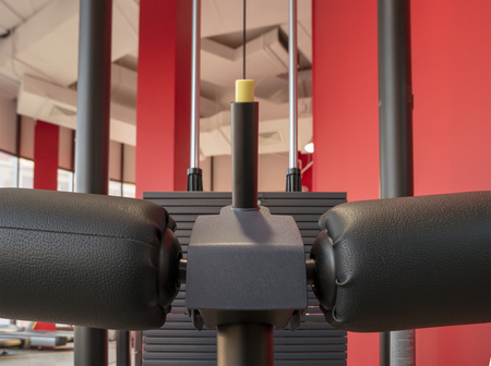 Closeup of soft cushions of gym trainer seat with interier on background
