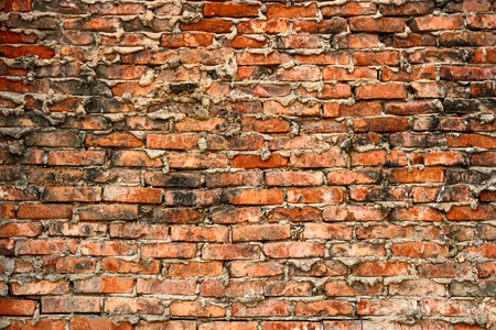 Background of cracked texture warehouse brick wall.の写真素材