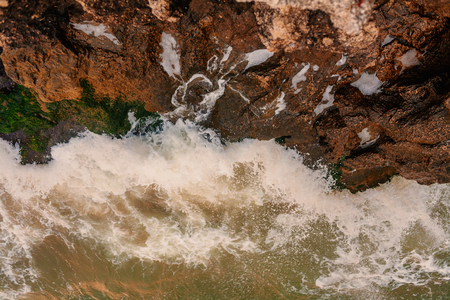 Aerial view of the disturbed sea and the rock. Aerial view of the tropical ocean and the rocky coast, toned in vintage colorの写真素材