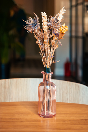 Dry flowers bouquet as decoration on table in cafeの写真素材