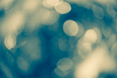 Dreamy teal and yellow bokeh lights for Xmas backdrop. defocused lights purple soft shade with flare, wallpaper for Xmas design.の写真素材