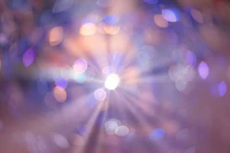 Abstract colorful xmas violet and pink glitter lights with shining flare. Christmas festive bokeh background. Defocused bokeh spots. Template for winter holidays designの写真素材