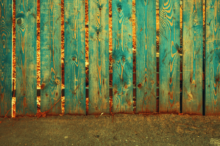 Old fence painted in teal color, copy-space.の写真素材