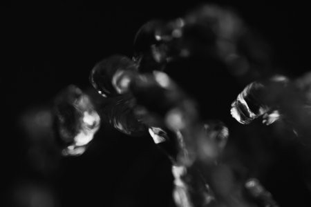 Water drops in air in dark selective focusの写真素材