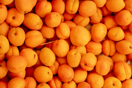 Orange Color Plums In Box On Market Shelves Top Viewの写真素材