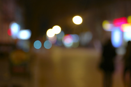 Defocused night city life scene - cars, people and street lamps, toned in retro colorの写真素材