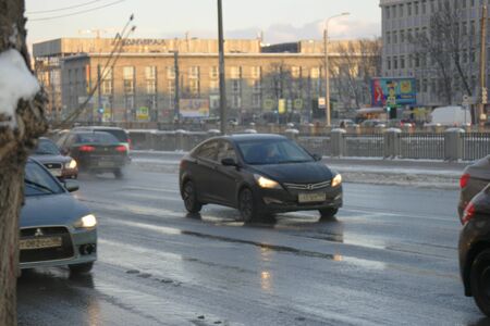 St.Petersburg Russia, 24 Feb 2016: Streets with cars covered with water mixed with snow after night snowfall, russian wintertimeのeditorial素材