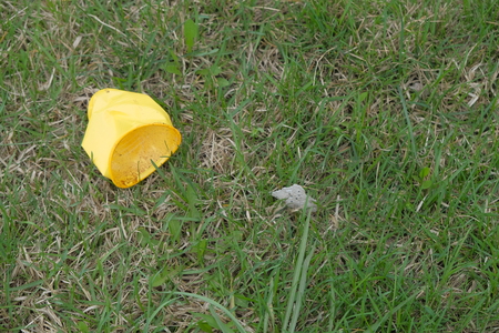 Plastic litter on grass, environmental protection conceptの写真素材