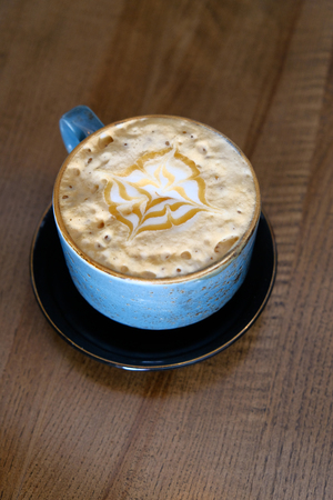 Verticl image of the Coffee cup with perfect latte art on foam top view on tabletopの写真素材