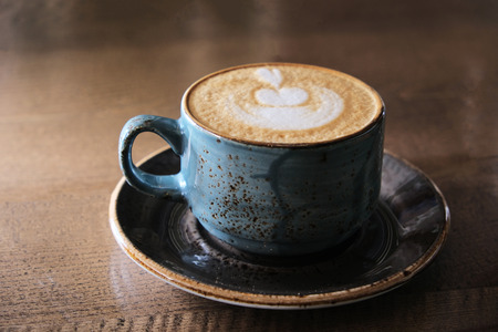 Japan style crocery Coffee cup with perfect latte art on foam side view on tabletopの写真素材