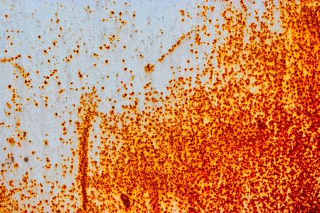 Painted iron sheet with a lot of rust where paint is peelingの写真素材