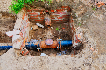 Old rusty sewage pipe in trench from above view with copy spaceの写真素材