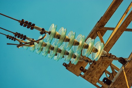 Glass electrical insulators on power-tower from below viewの素材 [FY310121461899]