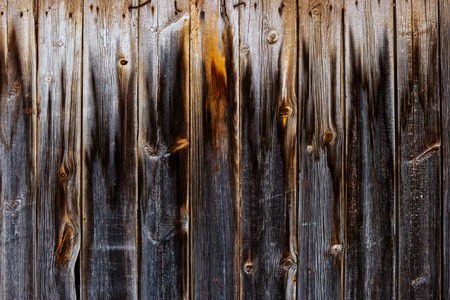 Aged Plank Fence With Footprint Of Fire On Its Surfaceの写真素材