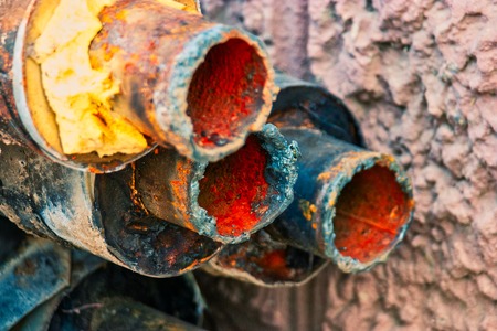 Closeup of old rusty pipes with footprint of welding on side