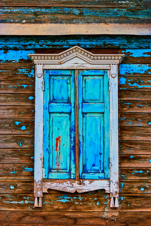 Obsolete window painted in worn sky blue colorの写真素材