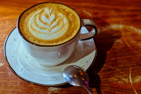 Cup of cappuccino coffe on tabletop from above viewの写真素材