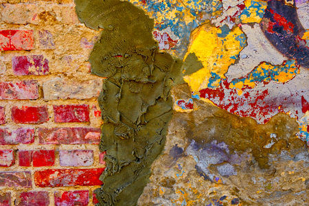 Weathered multicoloured wall with cement plaster, repair home workの写真素材