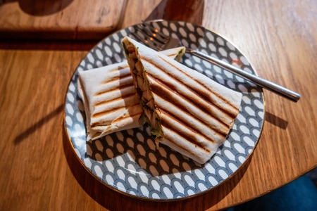 Shawarma cut in thwo parts on plate top viewの写真素材