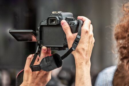 A man from a crowd shoots a street performance on a mirror camera blurred screen