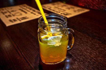 Fresh cold ice lemonade in glass jar on desk in cafe. Free space for your decoration elements and text.の写真素材