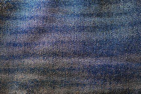 Photograph of a piece of bleached denim fabric. Casual modern wear fiber.の写真素材