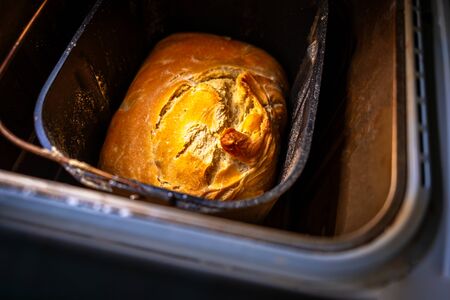 Look inside a bread maker with a home made bread with crunchy topの写真素材