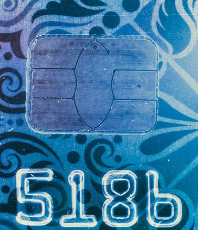 Macro image of bank credit card with part of the number and chip