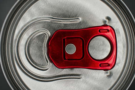 Macro photo top view of the lid of a can of fizzy drink open with the help of a ring-opener, shot with copyspace vertical imageの写真素材