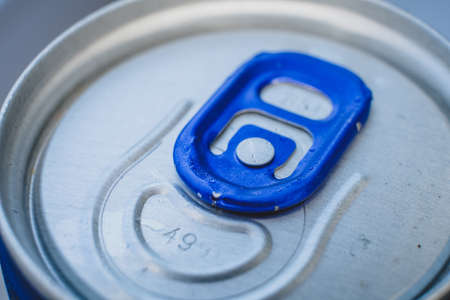 Closed aluminium soda can with blue opener, macro of lidの写真素材