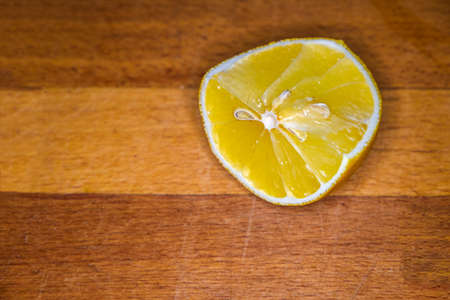 Lemon on wooden cutting board with a lot of copyspace.の写真素材