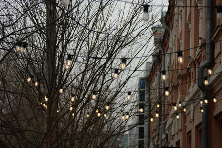 Moody depressive view of shop facade decorated with garland of lampsの写真素材