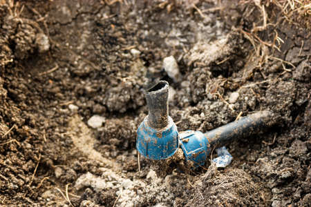 Broken watering pipe inside the ditch needs to be repaired befor new season of wateringの写真素材