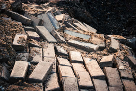 Landslide demolished pavement. Broken paved footpath on landslide.