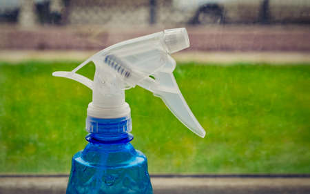 Blue washing spray head on the windowsill, with copyspaceの写真素材