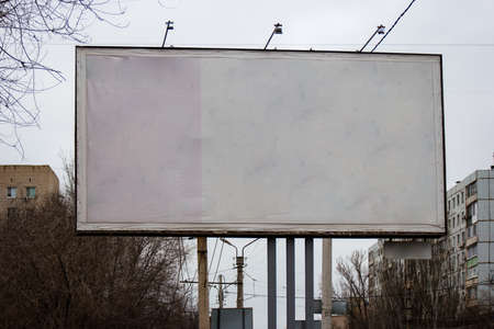 Blank roadside banner in front of city buildings. Blank presentation media mock up template poster.の写真素材