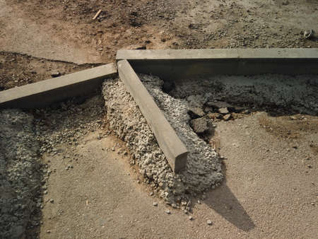 Foot path reconstruction. New curbstone installed and fixed with concrete, copyspace.の写真素材